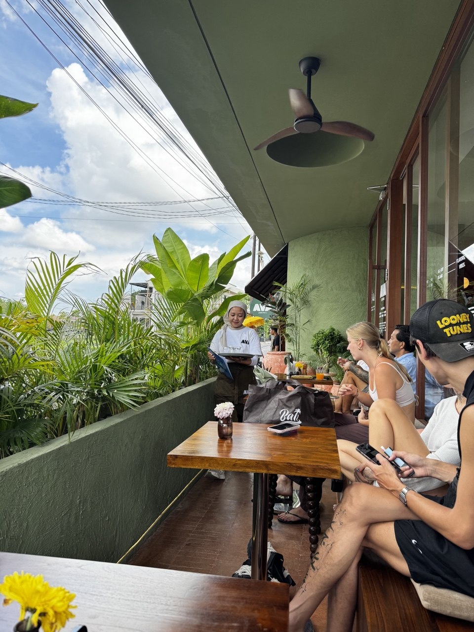 Guests on the garden-side terrace at AVA Bistro