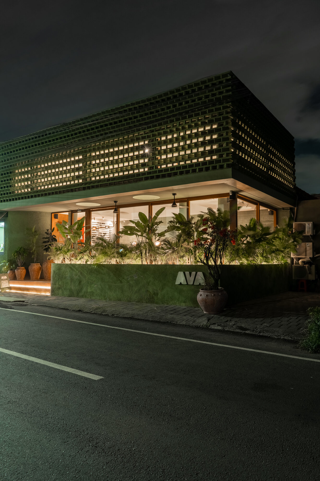 AVA Bistro exterior at night — green brick facade in Seseh, Bali